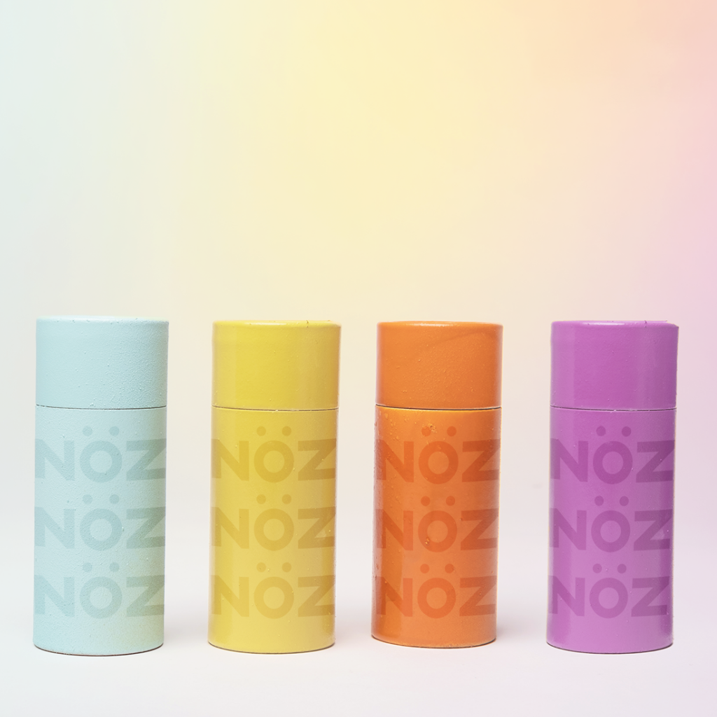 Noz sunscreen sticks in multiple colors that are environmentally friendly.